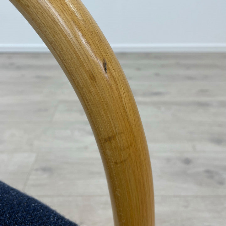 Møteromstol i blått trekk med treramme og bakben med metall