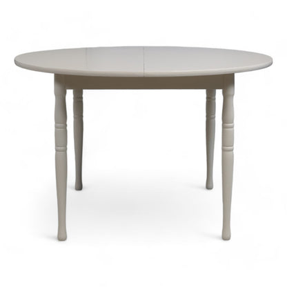 Hvitt rundt spisebord i tre med ileggsplate ø1120cm